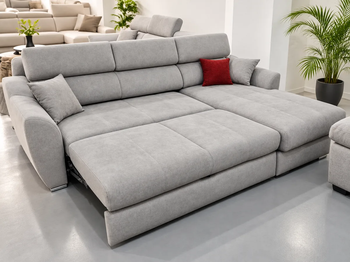 Sofá cama gris con superficie extendida en la exposición de Innova Descanso en La Laguna